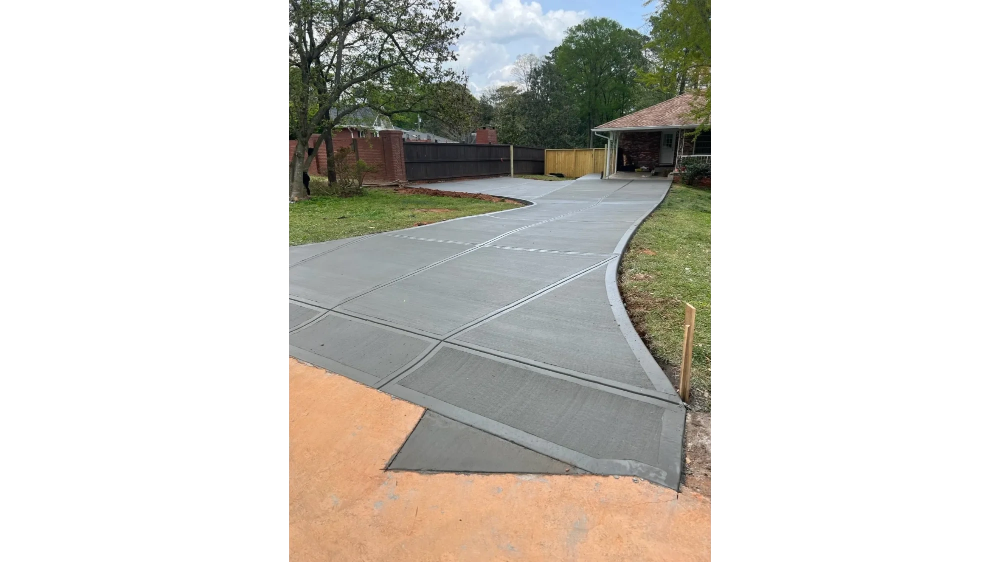 Curved concrete driveway installation in Oakland County, Michigan by Slab Happy Concrete