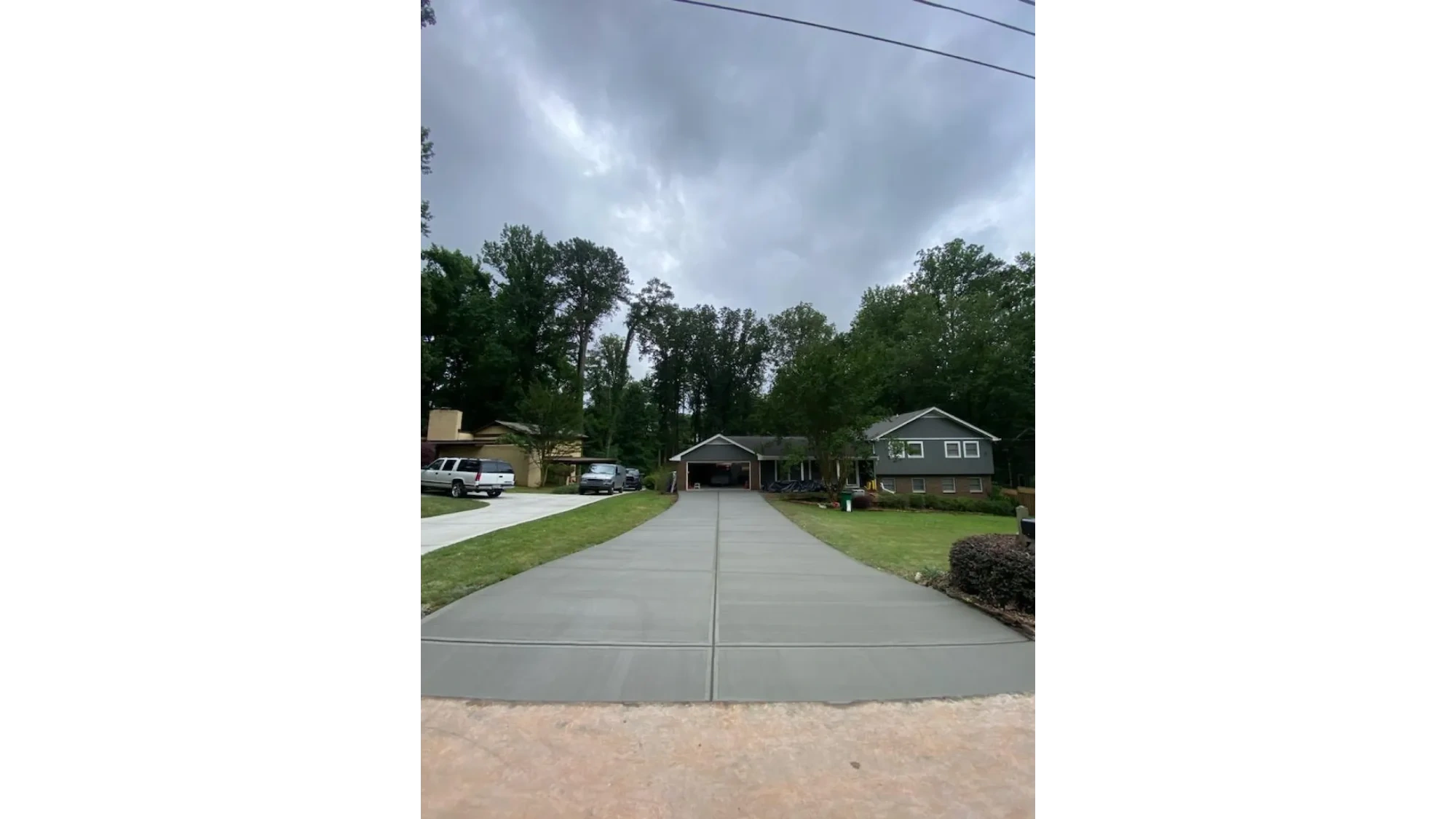 Long residential concrete driveway in Macomb County, Michigan by Slab Happy Concrete